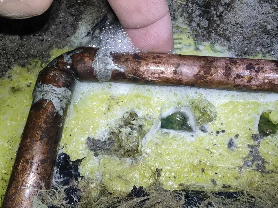 Copper pipework uncovered in a concrete floor during the hot-water leak investigation